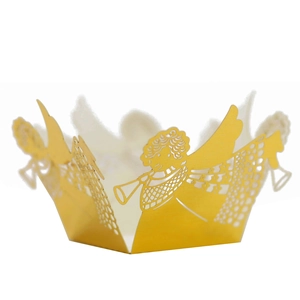 Macro detail of laser-cut golden angel hollow cupcake wrapper for wedding party decor