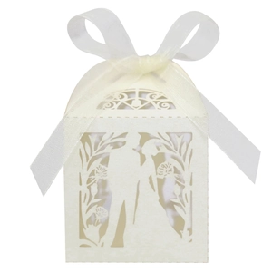 Detailed laser-cut ivory wedding favor box featuring bride and groom silhouette and ribbon