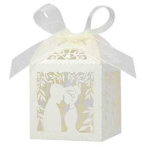 Laser-cut ivory wedding candy box featuring a romantic couple silhouette and white ribbon bow