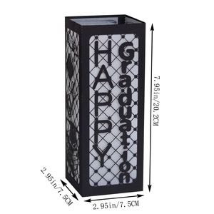 Detail of laser-cut black paper lantern with Happy Graduation text and cap motifs