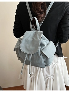 Minimalist light blue canvas backpack with drawstring flap closure and side pockets
