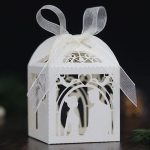Detailed laser cut white wedding candy box featuring a romantic bride and groom silhouette