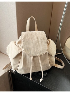 Chic beige canvas drawstring backpack for women with flap cover and side pockets