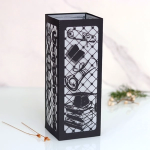 Close-up of black laser-cut paper lantern with Happy Grad text and mortarboard motif