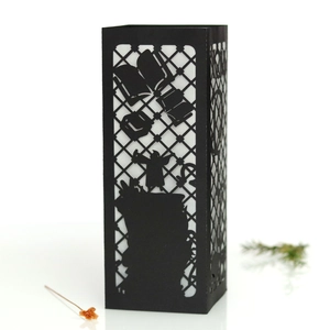 Detail of laser-cut black lantern with owl and lightning bolt paper silhouettes