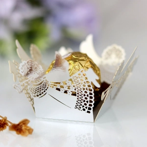 Detailed laser-cut angel design on white pearlescent paper candy favor box