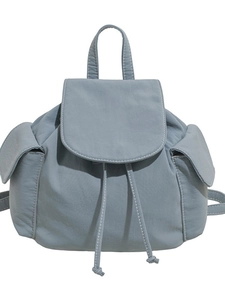 Minimalist light blue canvas backpack with drawstring closure and stylish flap pockets