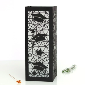 Detailed view of hollowed black GRAD paper lampshade for graduation party decor