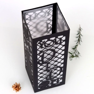 Detail of laser-cut 'YOU DID IT' black paper lantern lampshade for graduation party decor