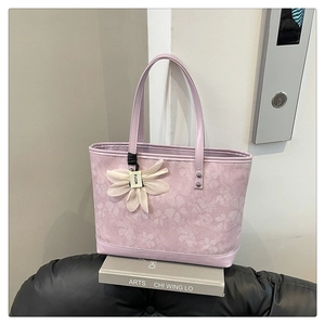 Detailed close-up of light purple floral embroidery on a chic large capacity tote bag