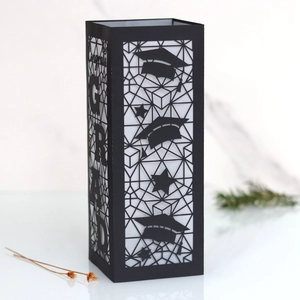 Detailed close-up of hollowed-out black paper graduation lantern with GRAD cutout