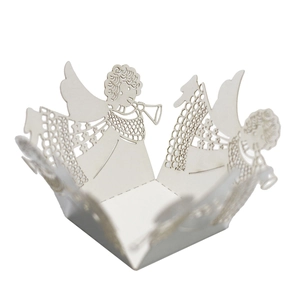Intricate laser-cut white paper cupcake wrappers with angel trumpet design for weddings