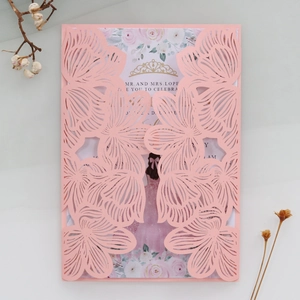 Detailed laser cut pink invitation cover with elegant flower patterns and inner card