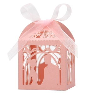 Pink laser-cut wedding favor box featuring romantic couple silhouette and organza ribbon bow