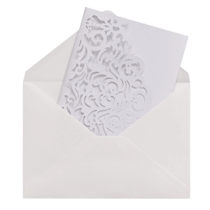 Elegant white laser-cut wedding invitation set with floral patterns and a matching envelope