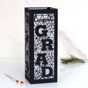 Detail of black hollow graduation lantern with Congrats GRAD text and cap cutout