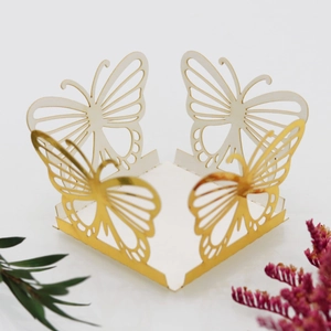 Detail view of laser-cut butterfly wedding candy box with hollow gold mirror finish decor