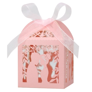 Laser-cut pink wedding favor candy box with silhouette engraving and white ribbon bow