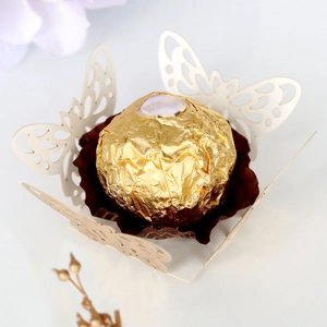 Macro shot of laser-cut butterfly chocolate holder with elegant hollow lace detail