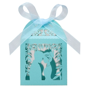 Detail of light blue laser cut candy box featuring a couple silhouette and ribbon bow
