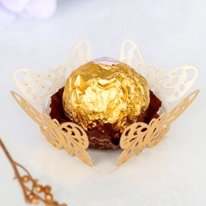 Detail showing hollow butterfly laser-cut chocolate holder made of premium off-white paper