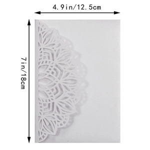 Close-up of laser-cut white wedding invitation cover with intricate mandala patterns