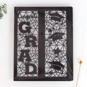 Macro shot of black laser-cut paper graduation lantern featuring Congrats GRAD motifs