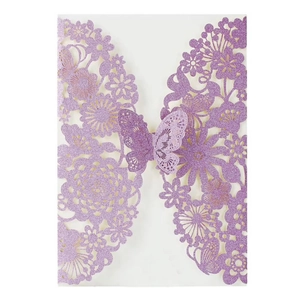Macro detail of laser-cut butterfly invitation card with purple glitter finish