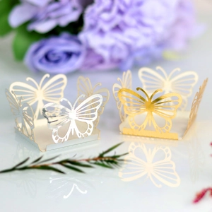 Detailed laser-cut silver and gold butterfly decorations with intricate hollow patterns