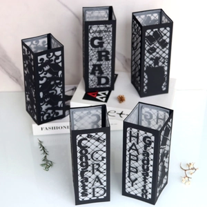 Detailed laser-cut black paper graduation lanterns with Congrats Grad hollow patterns