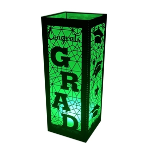 Close-up of black hollow-out Congrats GRAD paper lantern with green light effect