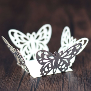 Close-up of laser-cut butterfly hollow pattern on gold-tone paper candy box decoration
