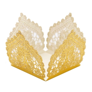 Detail of laser-cut gold hollow cupcake wrapper with elegant floral lace pattern decoration