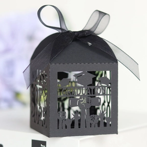 Detail of black laser-cut graduation candy box with silk ribbon and 2025 theme