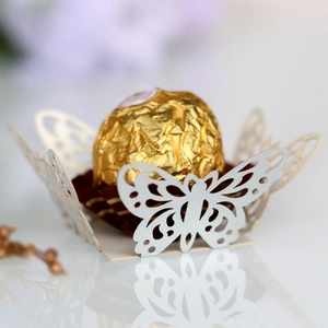 Detail of white laser-cut butterfly chocolate wrapper for wedding party favor decoration