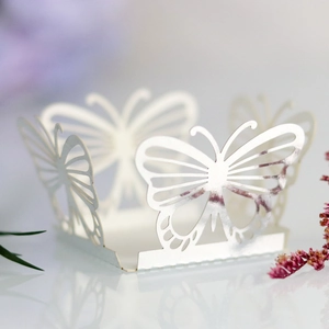 Macro detail of laser-cut hollow butterfly party favors with pearlescent finish