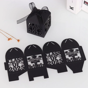 Flat-lay view of black laser-cut graduation candy boxes with Class of 2025 motifs