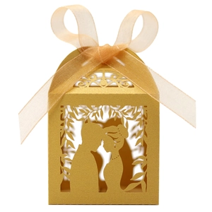 Macro detail of laser-cut wedding candy box with gold pearlescent finish and ribbon