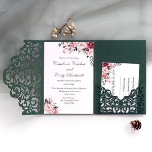 Macro view of laser-cut wedding invitation pocket with floral RSVP card inserts