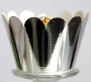 Macro shot of laser-cut silver mirror finish cupcake liners with elegant scalloped edges