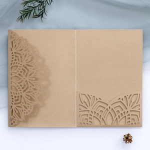 Laser cut kraft paper wedding invitation cover with intricate ethnic hollowed-out patterns