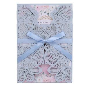 Detailed laser cut floral invitation with light blue sleeve and ribbon bow