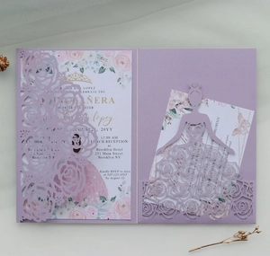 Macro detail of laser cut lavender rose pattern invitation with crown printed inner card