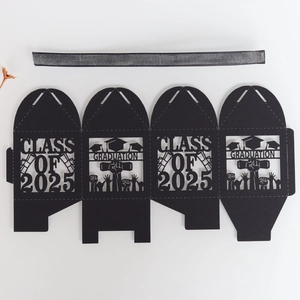 Flat lay of laser-cut Class of 2025 graduation gift box in black card with ribbon