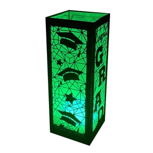 Close-up of black graduation paper lantern with hollowed-out star patterns and green LED light