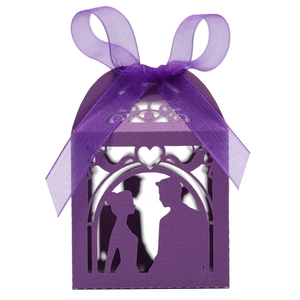 Macro view of purple laser-cut candy box featuring a romantic couple silhouette and ribbon