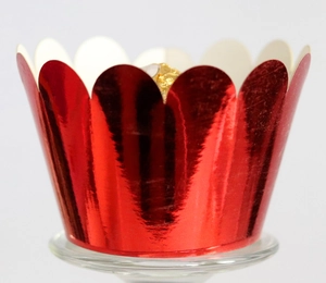 Close-up of laser-cut metallic red cupcake wrapper with scalloped edge design for dessert