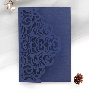 Detailed laser-cut dark blue invitation card cover with elegant European floral patterns