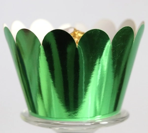 Close-up of metallic green scalloped cupcake wrapper with gold foil chocolate display