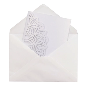 Detailed laser-cut mandala pattern on white wedding invitation card and envelope